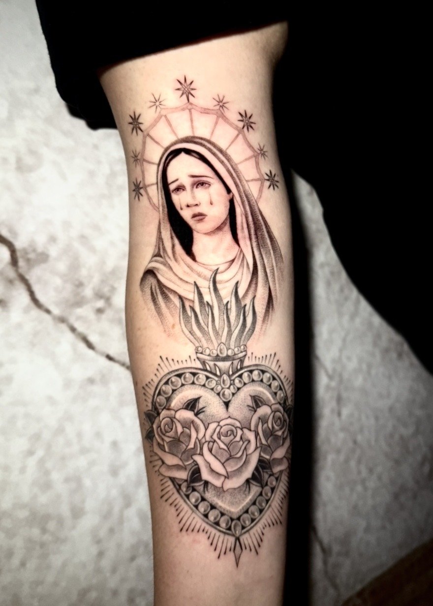 Black and grey Virgin Mary and sacred heart forearm tattoo by Evelyn Garcia