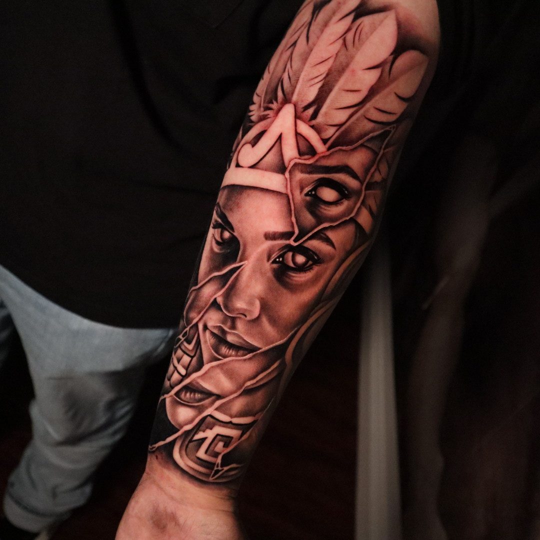 Black and grey woman portrait with feathers forearm sleeve, tattoo by Keaks Hurtado