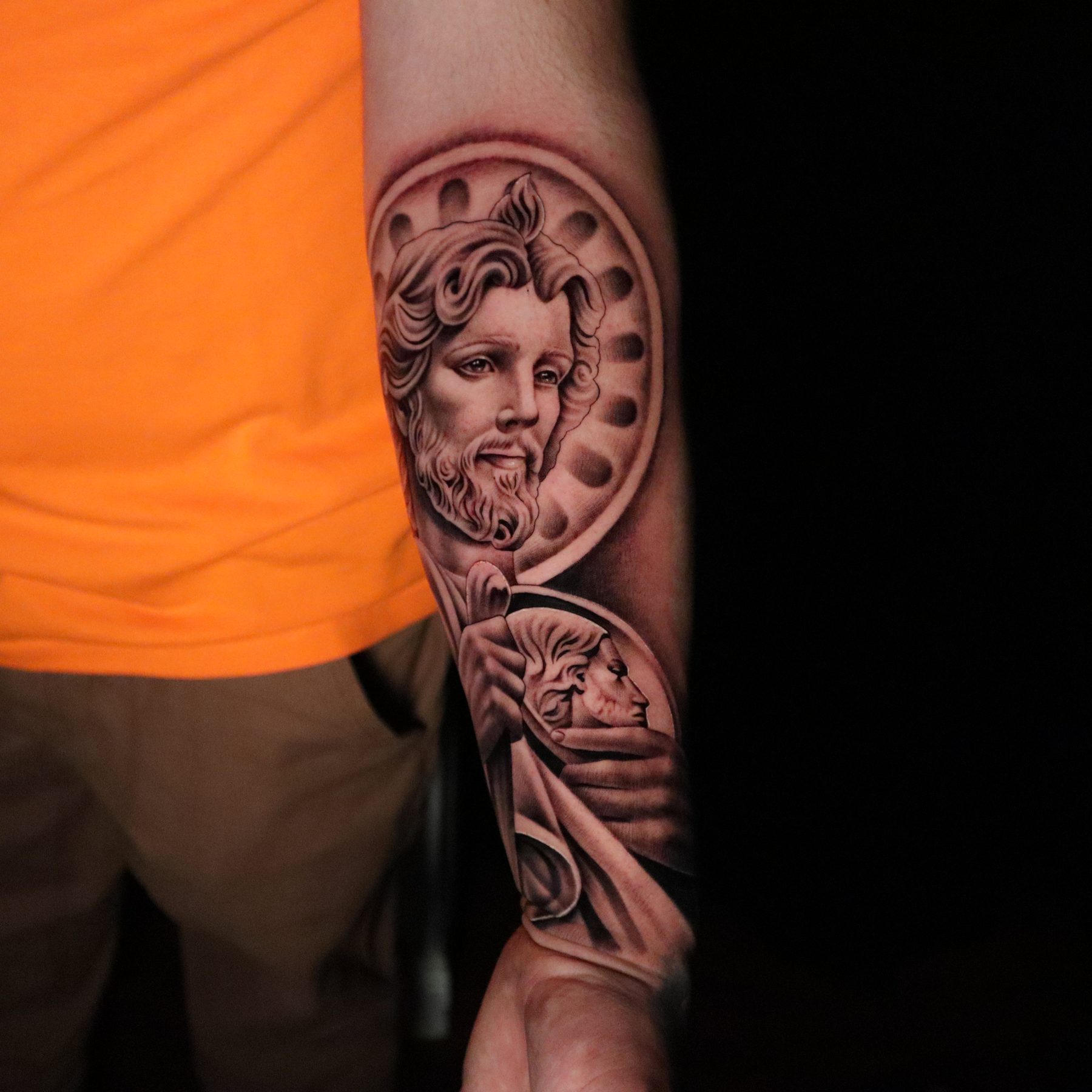 Black and grey saint portrait forearm sleeve, tattoo by Keaks Hurtado